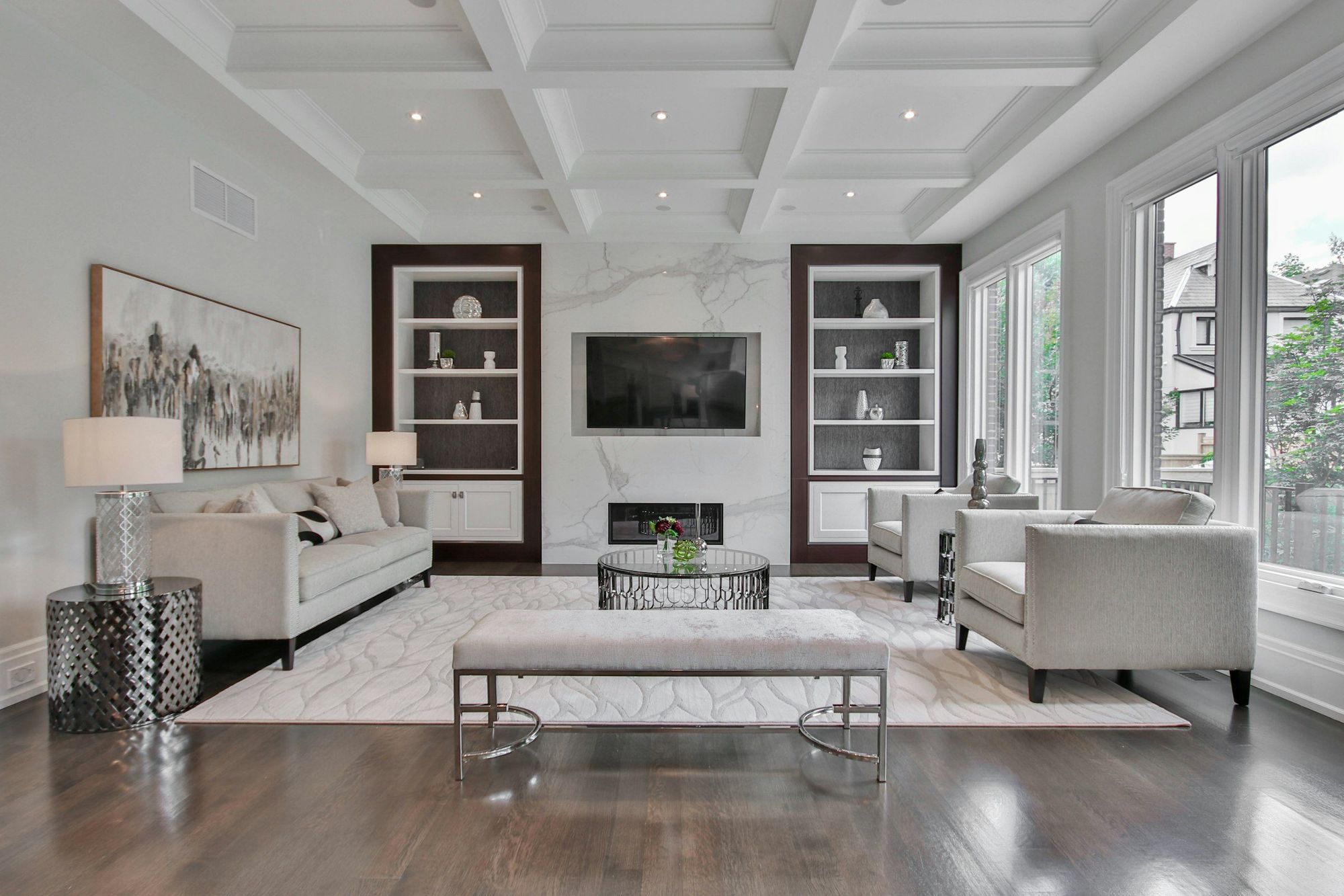 Dark built-in shelving around a marble fireplace